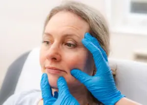 Facial aesthetics consultation at HAVA Aesthetics in Surrey with practitioner assessing lip and facial contour before dermal filler treatment.