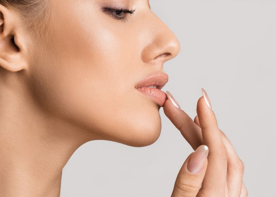 woman touching fuller lips after treatment
