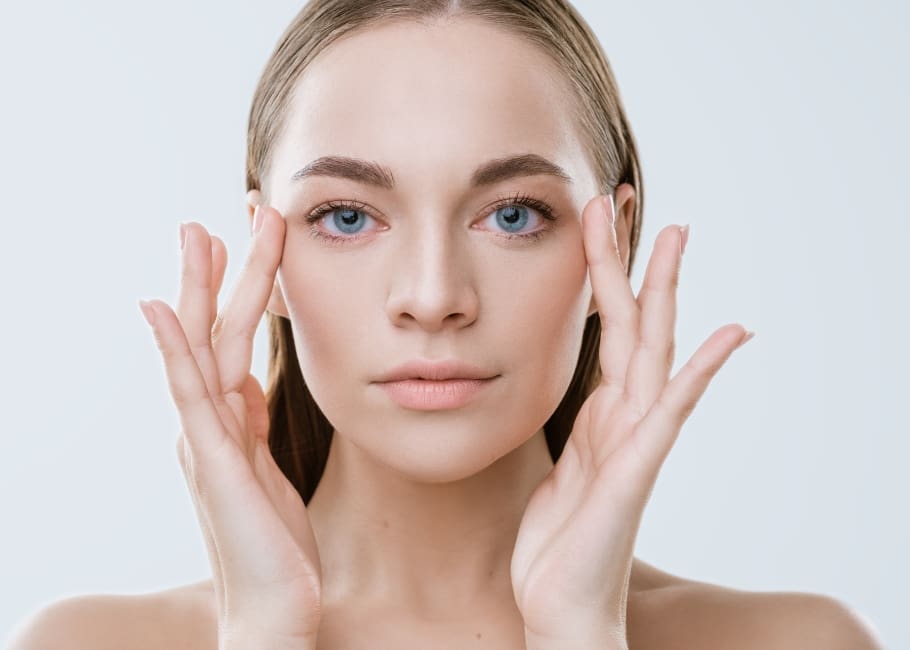 woman touching her face after fillers